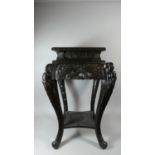 A Large Ebonised Vase Stand with Carved Panels and Cabriole Legs in the Form of a Dragons, Stepped