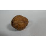 An Oriental Walnut Shell with Profusely Carved Decoration