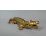 A Novelty Gilt Metal Cigarette Box in the Form of a Crocodile with Hinged Lid Revealing Sections for