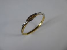 An 18ct Yellow and White Gold Bangle, approx 11.8 gms.