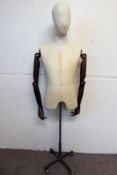 A Fabric Mannequin Male Torso with articulated wooden arms, the mannequin on metal support with