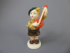 A 1950s Goebel Hummel Ceramic Prototype figurine of a boy playing a mandolin, stamped KF37 to