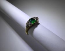 An Antique 18ct Yellow Gold Emerald and Diamond Ring, the vivid green emerald cut stone flanked by