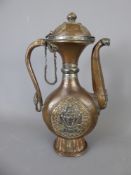 An 18th Century Tibetan Copper and Silver Libation Ewer, having lotus foot with serpent handle,