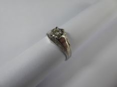 An 18ct White Gold Diamond Ring, size N, the diamonds approx 8 pts, the ring having bark finish