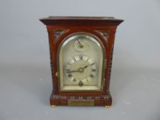A late 19th Century Mahogany-Cased Desktop Clock, mounted on brass button feet, made by Goldsmiths &