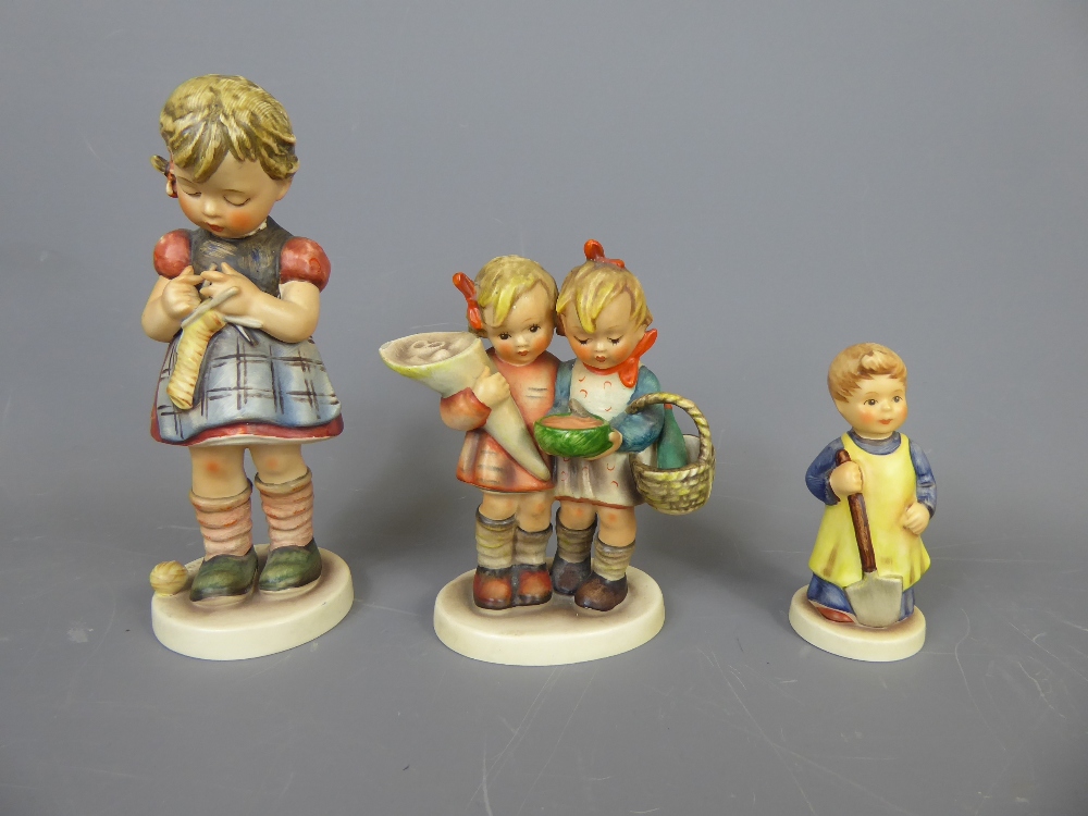 Three Goebel Figurines, including 'Girl with Spade', 'Girl Knitting', 'Bearing Gifts', together with