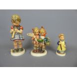 Three Goebel Figurines, including 'Girl with Spade', 'Girl Knitting', 'Bearing Gifts', together with