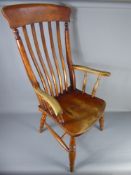 A Pine Fireside Elbow Chair, with slat back and turned legs.