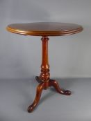 A Mahogany Wine Table, turned column on tripod base, approx 59 x 78 cms.