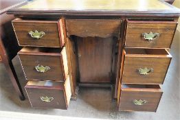 A Georgian-Style Mahogany Ladies Kneehole Desk, the desk having a brown-tooled leather surface,