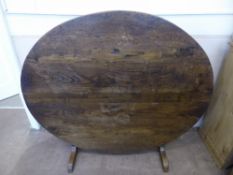 A Large Antique Oval Oak Tilt-Top Dining Table supported by a square frame on two legs, approx 150 x