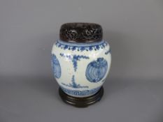 An 18th Century Chinese Blue and White Ginger Jar, Stand and Cover, hand painted with bats,