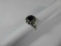 An 18ct White Gold Sapphire and Diamond Ring, the oval sapphire approx 7.7 x 6.6 mm, with diamond