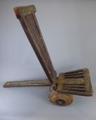 A Carved Slat Back Wooden Ethiopian Chair, seat extending as a back rest, approx 120 cms long,