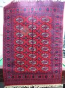 A Keshan Wool Carpet, geometric medallion design, claret with cream highlights, approx 140 x 200