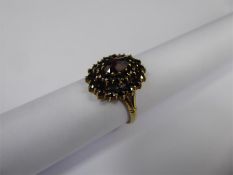 An Antique Garnet Oval Cluster Ring.