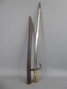 An Antique French Steel and Polished Brass Bayonet in Steel Scabbard