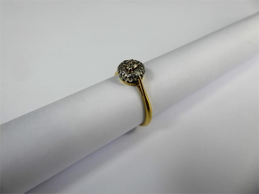 An 18ct Yellow Gold and Platinum Diamond Ring.