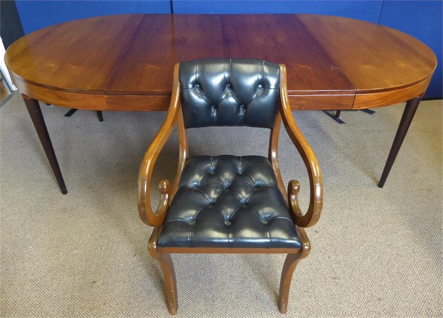 A Rosewood Circular Dining Table and Chairs