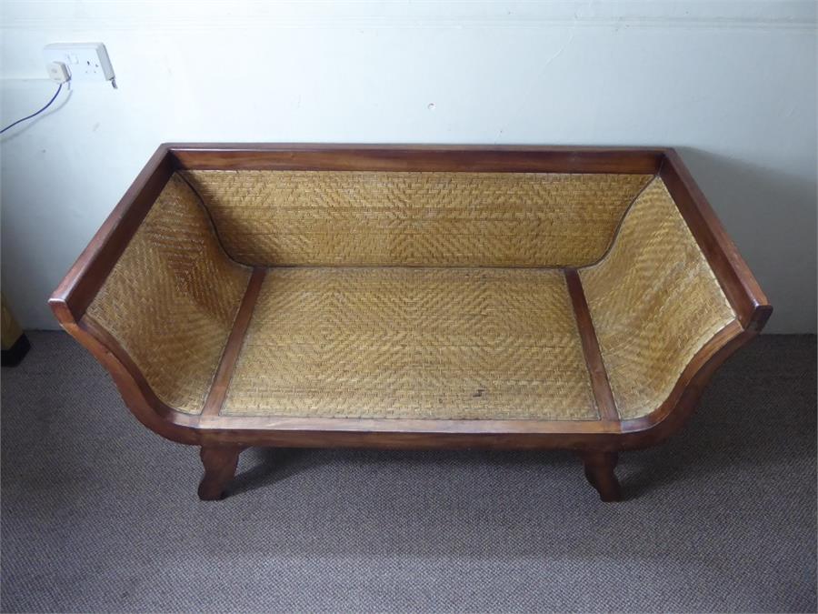 A South Asian-Style Rattan Conservatory Couch.