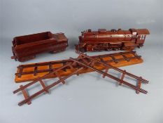 A Hand-Made Carved Teak Locomotive, Tender and Rails