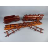 A Hand-Made Carved Teak Locomotive, Tender and Rails