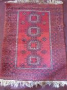 A Persian Wool Burgundy Carpet.