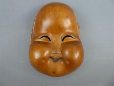 A Japanese Wooden Mask of Okame (Otafuku).