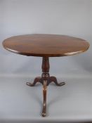 An Antique Oak Circular Occasional Table.