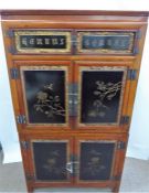 A Chinese Late 19th Century Qing Dynasty Cherry and Fir Wood Cupboard.