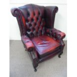 A Burgundy Chesterfield-Style Button-Back Arm Chair