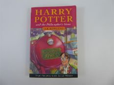 Paper Back Edition of Harry Potter and the Philosopher's Stone.