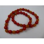 A Butterscotch and Red Amber Beaded Necklace