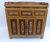 A 20th Century Chinese Cypress and Mahogany Tea Table