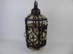 A Vintage Cast Iron and Glass Outdoor Wall Hanging Lantern with Bracket