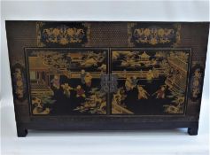 A Chinese Late 19th Century Elm Qing Dynasty Black Lacquer Low Cabinet.