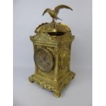 A Brass Mantle Clock With Bird Finial.