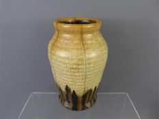 A Hillstonia Pottery vase, of baluster form, the lightly ribbed body decorated in orange with