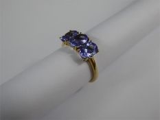 A 9ct Yellow Gold and Tanzanite Three Stone Ring