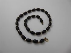 A Set of Antique Elongated Dark Red Amber Beads