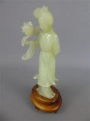 A Chinese Celadon Green Carving of a Lady