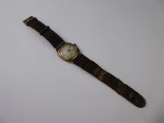 A 9ct Yellow Gold Gentleman's Wrist Watch, the watch having a white engine turned face with