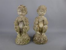 A Pair of Composite Stone Weathered Garden Figures