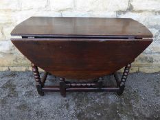 An Antique Oak Drop-leaf Dining Room Table and Six Chairs