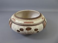 A Stoneware Inverted Rim Bowl with cream/red/brown decoration