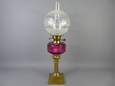 A Victorian Cranberry Glass Oil Lamp