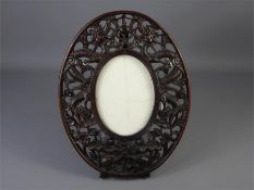 A Chinese Rosewood Oval Easel Frame