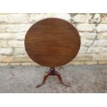 An Antique Circular Mahogany Tilt-Top Table