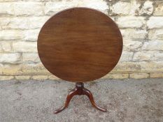 An Antique Circular Mahogany Tilt-Top Table